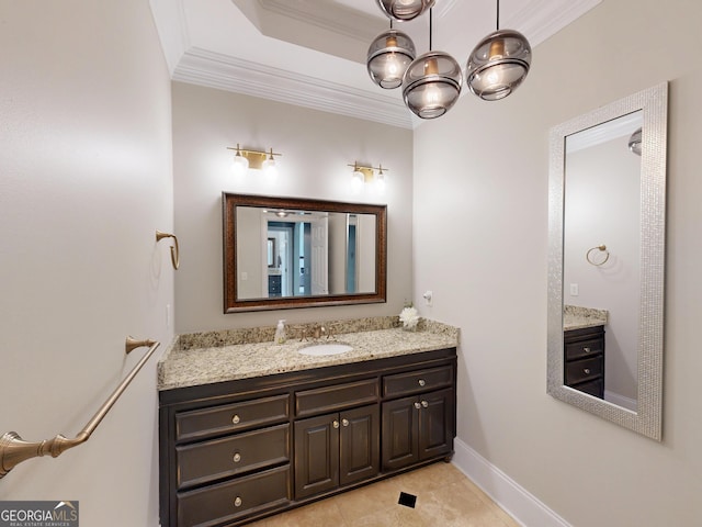 bathroom with baseboards, a tray ceiling, crown molding, and vanity