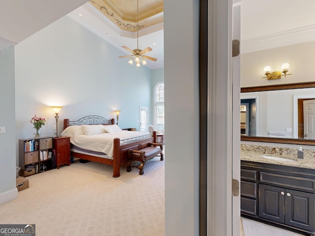 bedroom featuring light carpet, ornamental molding, and a sink