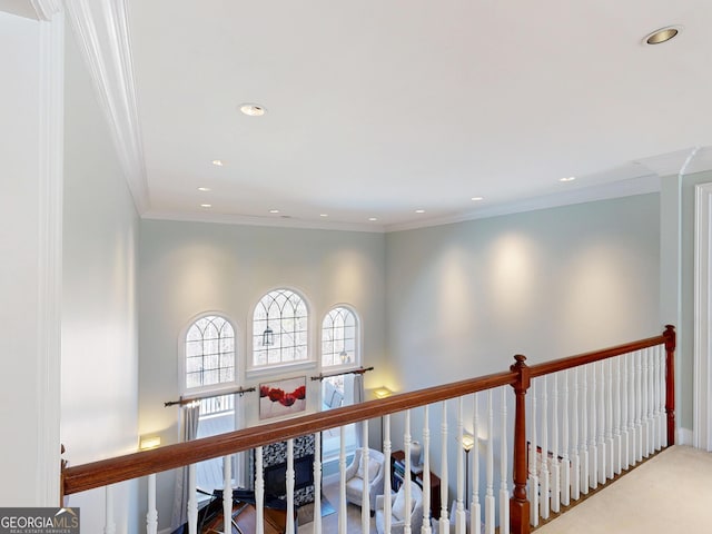 hallway featuring ornamental molding, recessed lighting, carpet, and an upstairs landing