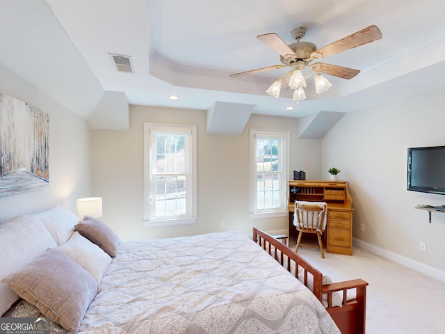 bedroom featuring a raised ceiling, visible vents, light carpet, and baseboards