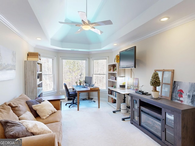 office featuring a raised ceiling, a ceiling fan, light colored carpet, crown molding, and recessed lighting