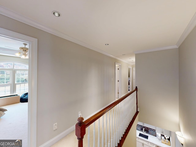 staircase featuring baseboards, recessed lighting, carpet flooring, and crown molding