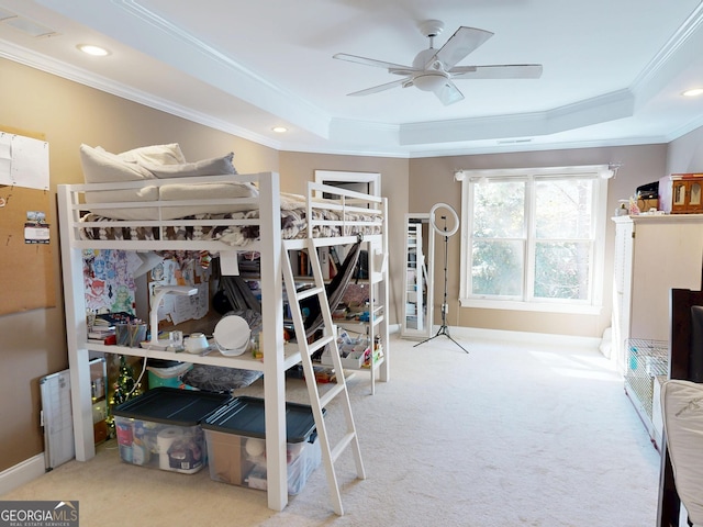 bedroom featuring ornamental molding, a raised ceiling, and baseboards