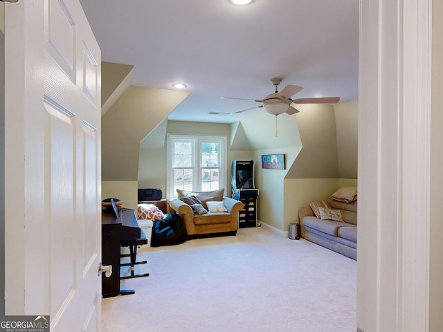 interior space with visible vents, baseboards, a ceiling fan, vaulted ceiling, and carpet floors