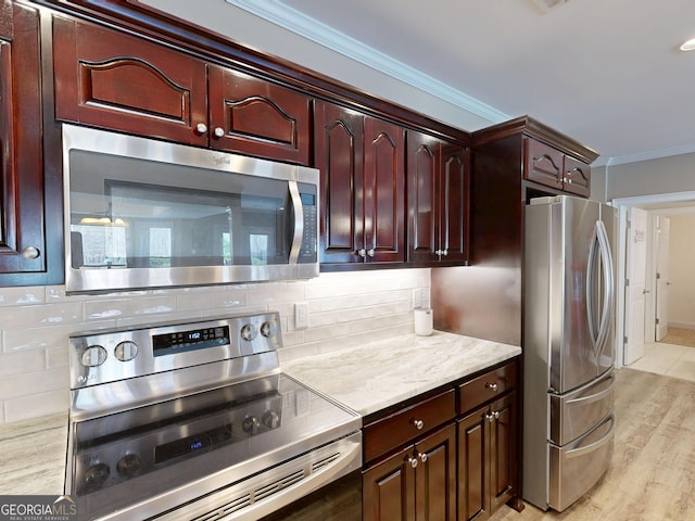 kitchen with light wood finished floors, appliances with stainless steel finishes, ornamental molding, dark brown cabinets, and backsplash