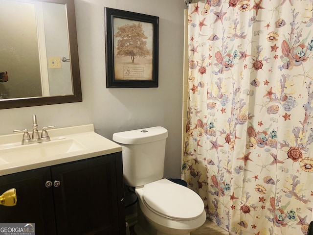 bathroom with vanity, a shower with shower curtain, and toilet