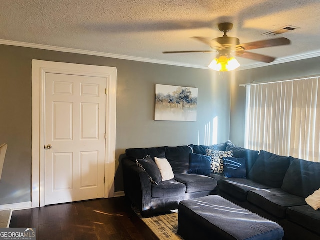 living room with crown molding, ceiling fan, dark hardwood / wood-style flooring, and a textured ceiling