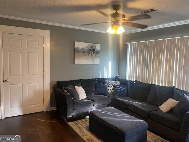 living room with ceiling fan, ornamental molding, dark hardwood / wood-style flooring, and a textured ceiling