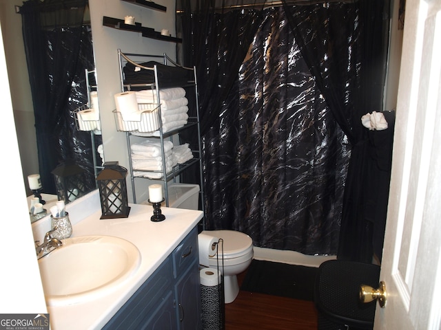 bathroom with vanity, hardwood / wood-style flooring, and toilet