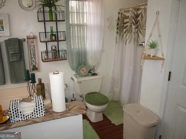 bathroom featuring hardwood / wood-style flooring and toilet