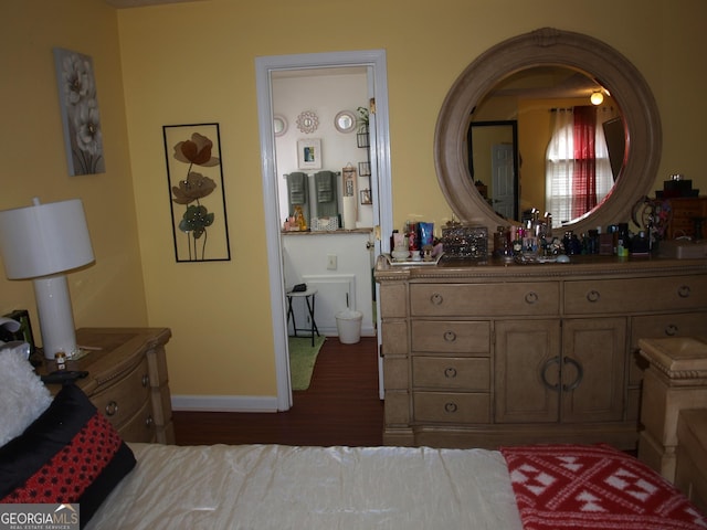 bedroom with dark hardwood / wood-style floors