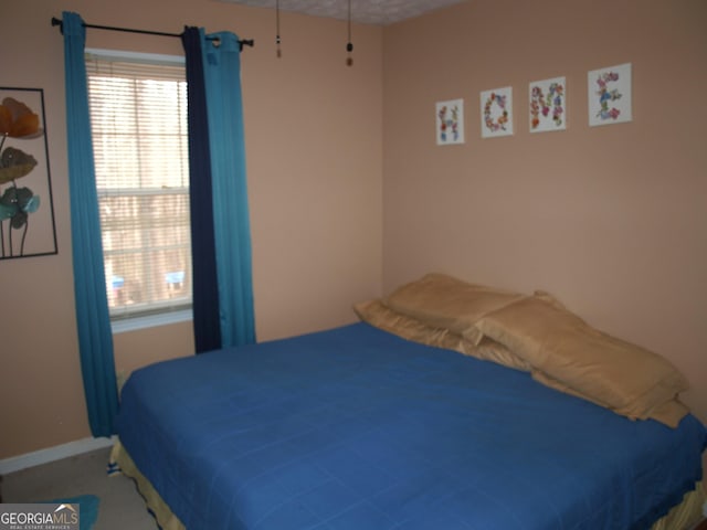 3738 Windy Hill Dr SE, Conyers, GA 30013 - bedroom featuring multiple windows, baseboards, and carpet flooring
