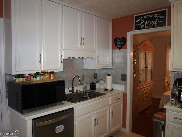 kitchen featuring white cabinetry, sink, backsplash, and dishwasher