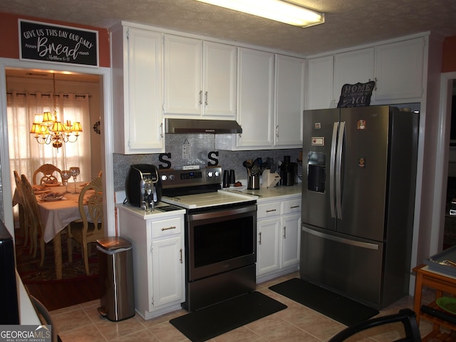 kitchen with light tile patterned floors, white cabinetry, stainless steel appliances, tasteful backsplash, and a chandelier