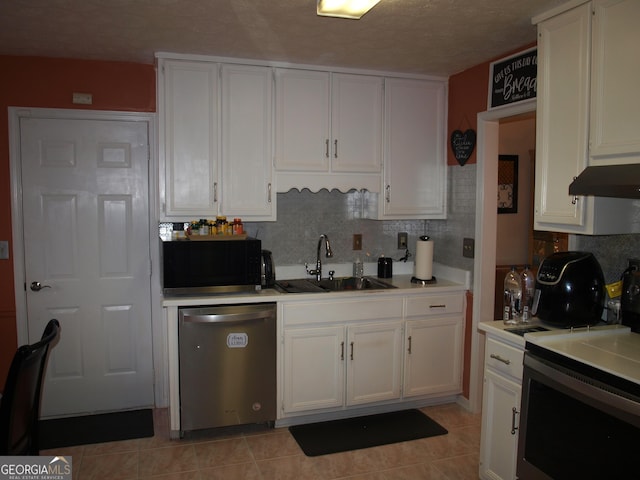 kitchen with sink, light tile patterned floors, white cabinets, decorative backsplash, and stainless steel dishwasher