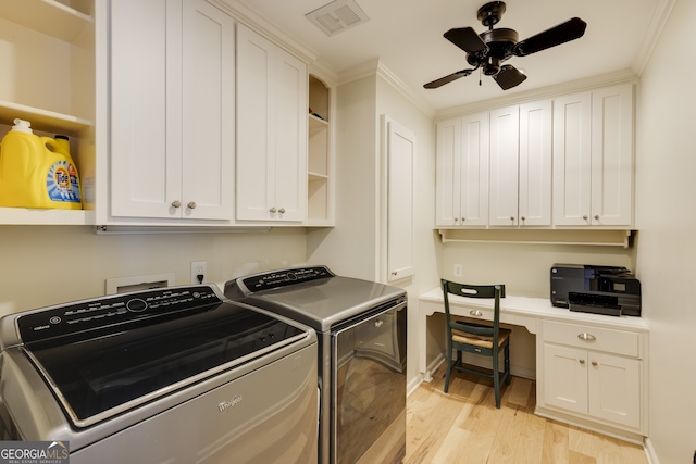 clothes washing area featuring cabinets, ceiling fan, light hardwood / wood-style floors, crown molding, and washer and clothes dryer