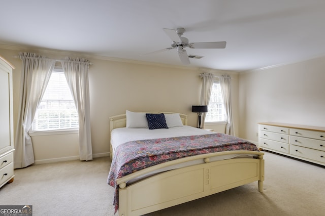 bedroom with ornamental molding, light colored carpet, and ceiling fan