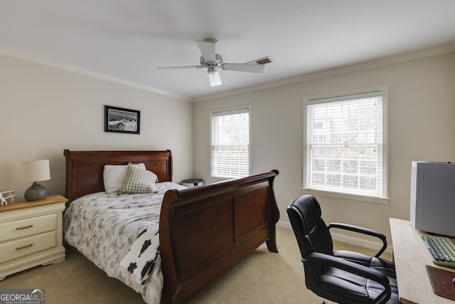 bedroom with crown molding, light colored carpet, and ceiling fan