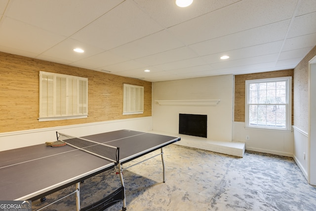 recreation room featuring a drop ceiling