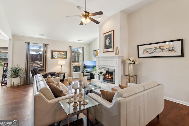 living room with vaulted ceiling, ceiling fan, and dark hardwood / wood-style floors