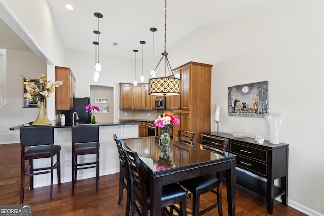 dining room featuring dark hardwood / wood-style flooring and lofted ceiling