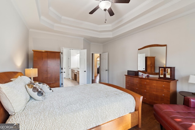 bedroom featuring a raised ceiling, ceiling fan, and ornamental molding