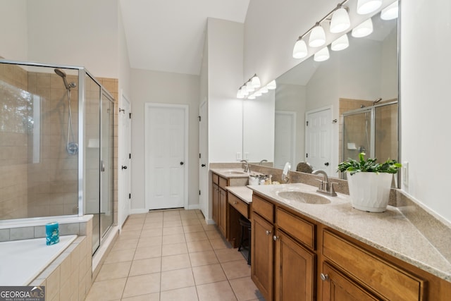 bathroom featuring tile patterned floors, vaulted ceiling, an enclosed shower, and vanity