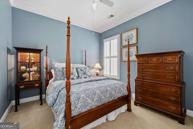 carpeted bedroom featuring ornamental molding and ceiling fan