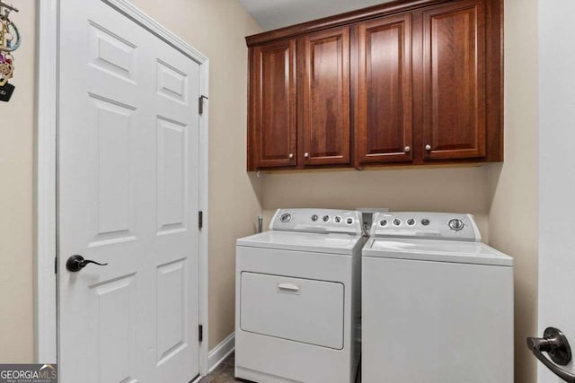 laundry area with cabinets and separate washer and dryer