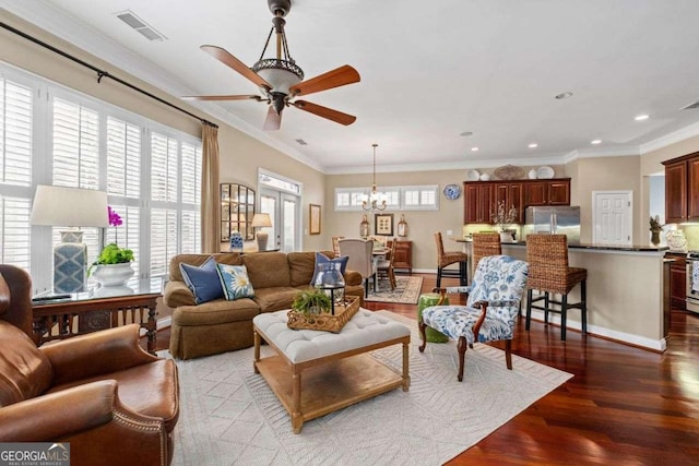 living room featuring ornamental molding, ceiling fan with notable chandelier, and dark hardwood / wood-style flooring