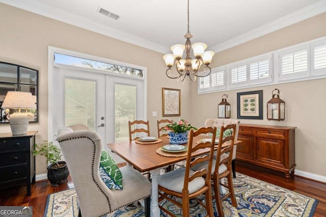 dining area with ornamental molding, dark hardwood / wood-style floors, and french doors