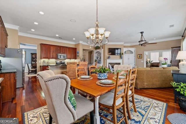 dining space with ornamental molding, dark hardwood / wood-style floors, and ceiling fan with notable chandelier