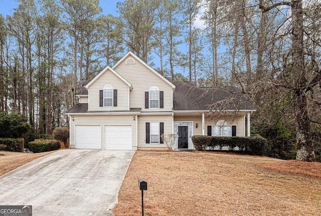 front facade featuring a garage and a front lawn