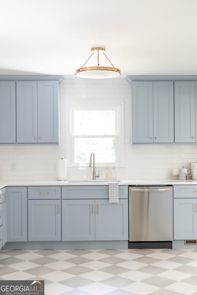 kitchen with tasteful backsplash, hanging light fixtures, sink, and dishwasher