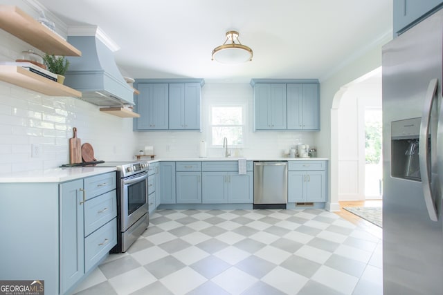 kitchen with sink, decorative backsplash, ornamental molding, and stainless steel appliances