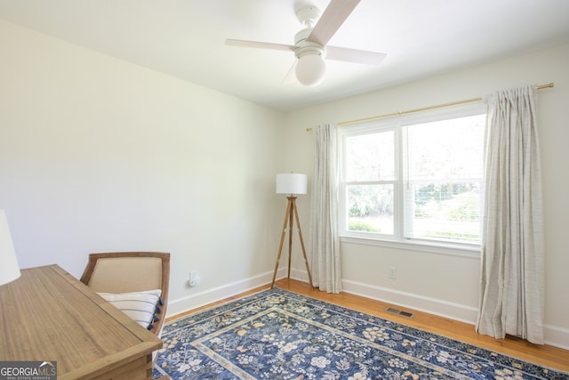 office space with hardwood / wood-style flooring and ceiling fan