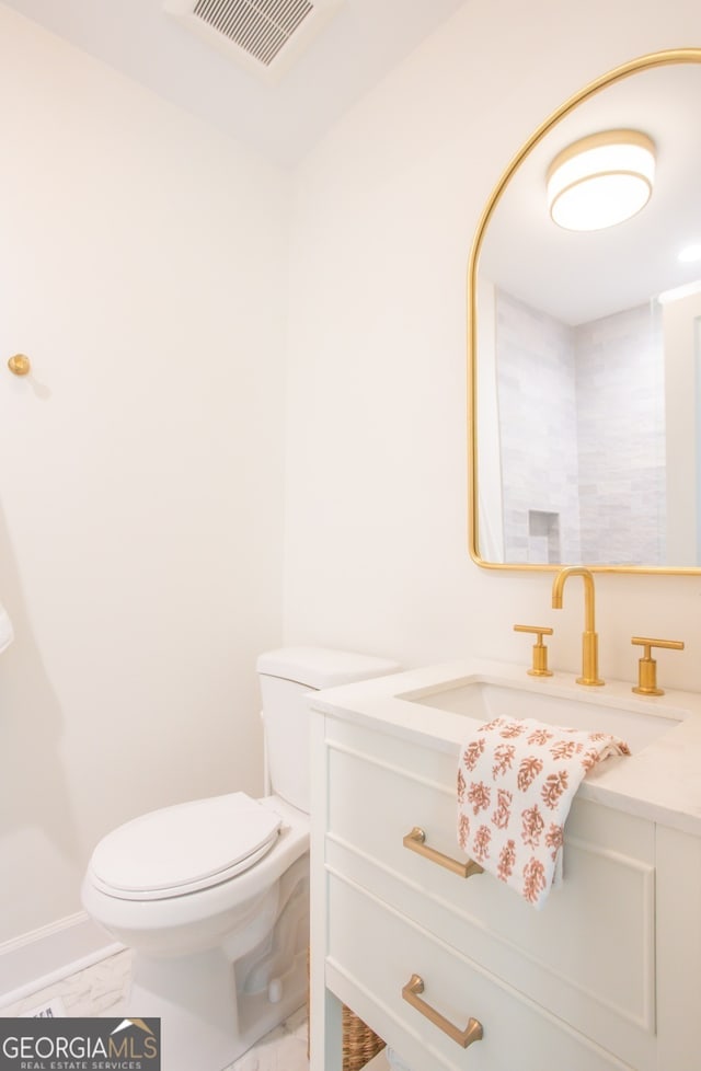 bathroom featuring vanity and toilet