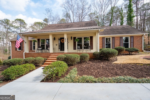 single story home featuring covered porch