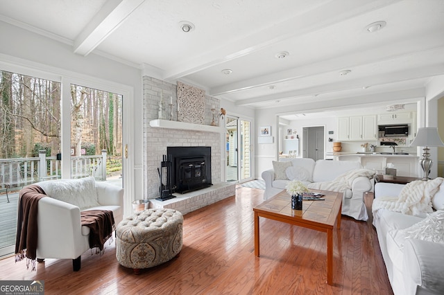 living room featuring wood-type flooring and beam ceiling