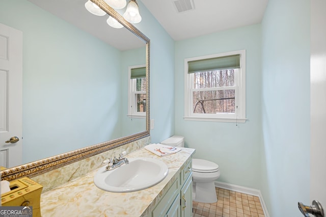 bathroom featuring vanity and toilet