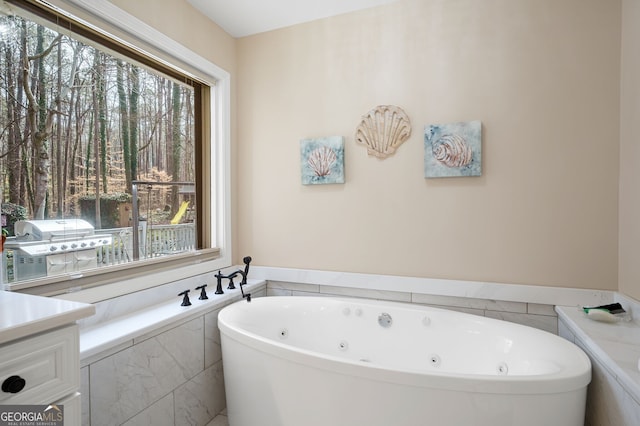 bathroom featuring a wealth of natural light and a relaxing tiled tub