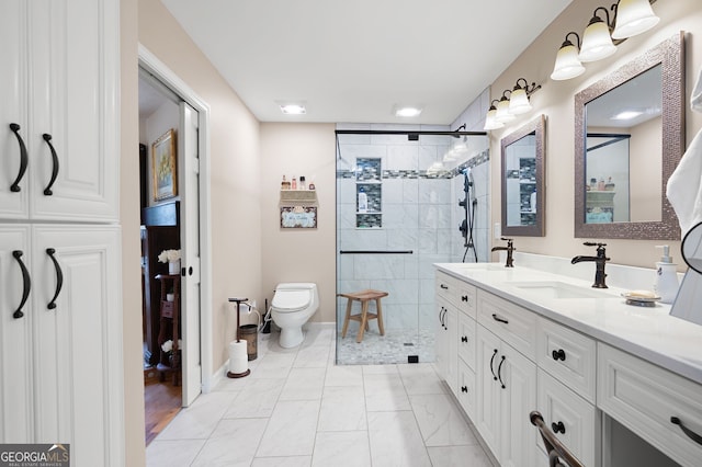 bathroom featuring vanity, toilet, and a shower with door