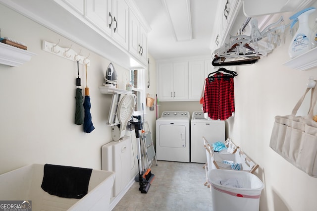 laundry room with cabinets and washing machine and clothes dryer