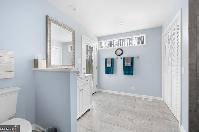 bathroom featuring vanity, toilet, and tile patterned flooring