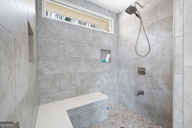 bathroom with tiled shower