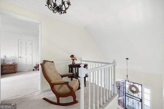 sitting room featuring vaulted ceiling, carpet floors, and an inviting chandelier