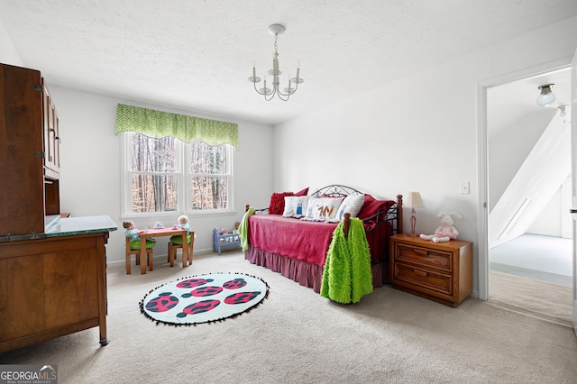 carpeted bedroom featuring a chandelier and a textured ceiling