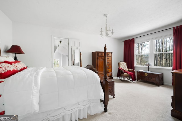 bedroom with light colored carpet and a textured ceiling