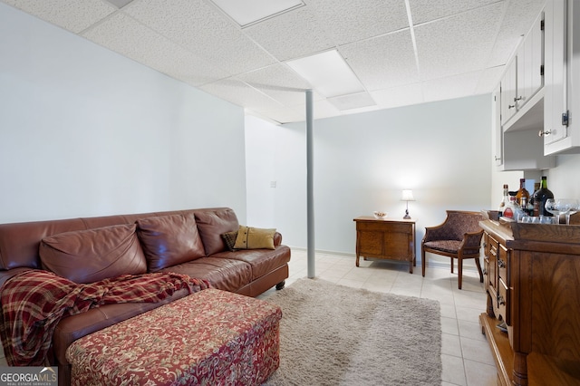 living room featuring light tile patterned flooring and a paneled ceiling