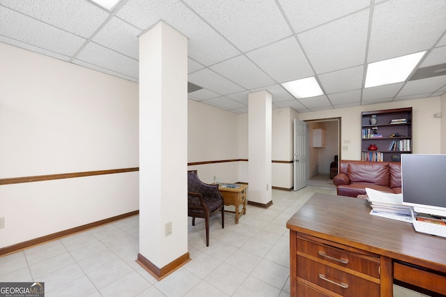 office space featuring light tile patterned flooring and a paneled ceiling